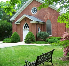 Front of HT church in spring, bench in foreground