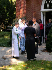 Asst Rector Mariann Babnis greets parishioners