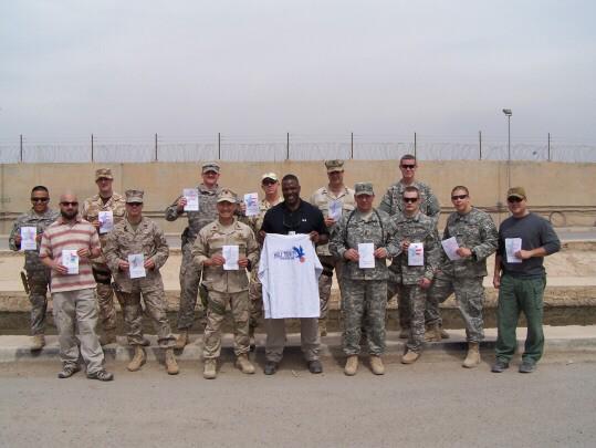 Troops holding up cards and the HTED t-shirt