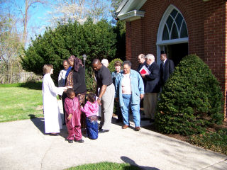 Parishioners greet the Rector and assistant rector while leaving the 8AM service